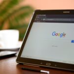 Samsung tablet on desk showing Google homepage, perfect for technology-related content.